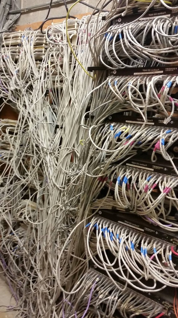 Unorganized commercial network cabling before Aaron Tech cleanup